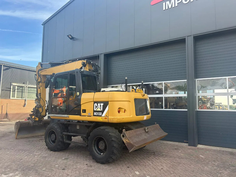 Caterpillar M313D - Escavadeira de rodas: foto 2 Caterpillar M313D - Escavadeira de rodas: foto 2