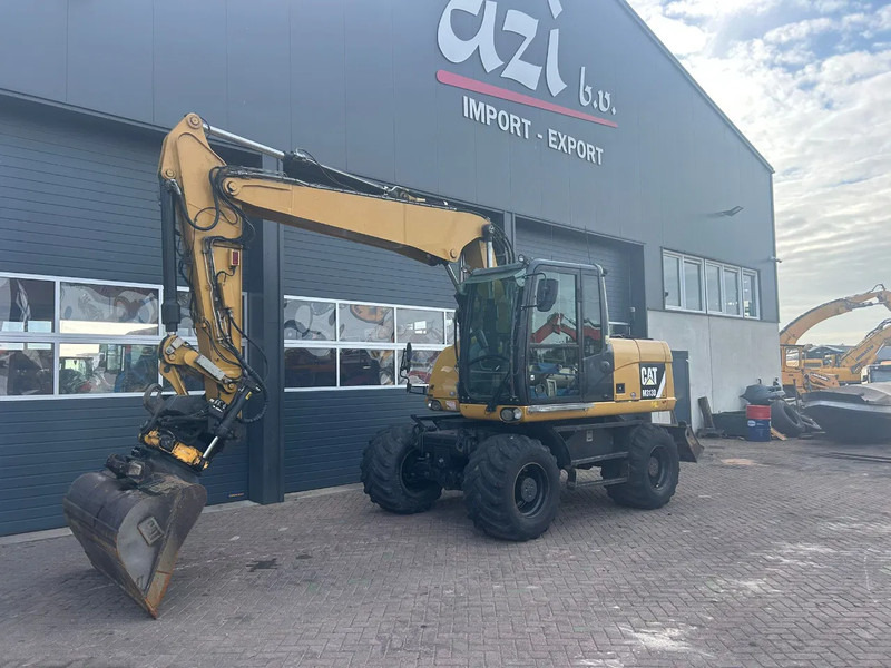 Caterpillar M313D - Escavadeira de rodas: foto 1 Caterpillar M313D - Escavadeira de rodas: foto 1