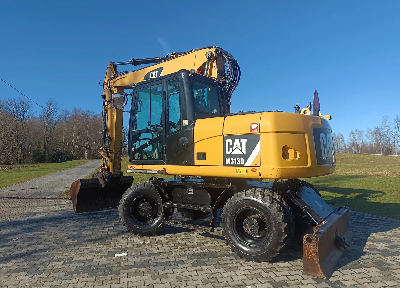 CATERPILLAR M313D - Escavadeira de rodas: foto 1 CATERPILLAR M313D - Escavadeira de rodas: foto 1
