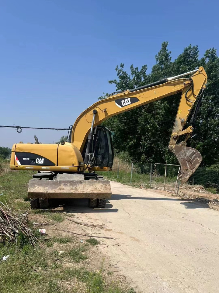 CATERPILLAR M317 - Escavadeira de rodas: foto 1 CATERPILLAR M317 - Escavadeira de rodas: foto 1