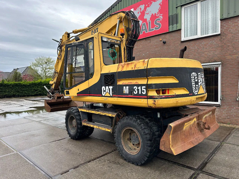 Caterpillar M315 +ROTO CE - Escavadeira de rodas: foto 4 Caterpillar M315 +ROTO CE - Escavadeira de rodas: foto 4